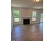 Open concept living room with fireplace and natural light from windows and sliding doors at 123 Sage Ln # 010, Four Oaks, NC 27524