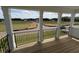 Covered porch with black metal railing overlooks the landscaped front yard at 123 Sage Ln # 010, Four Oaks, NC 27524