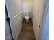 Small powder room featuring a toilet and wood-look flooring at 123 Sage Ln # 010, Four Oaks, NC 27524