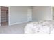 Bedroom featuring carpet floors and an open doorway into a walk-in closet at 6059 Scalybark Road, Durham, NC 27712