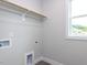 Functional closet with a wooden rod and ample storage space near a window at 6059 Scalybark Road, Durham, NC 27712