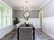 Dining room features contemporary chandelier and wainscoting at 6059 Scalybark Road, Durham, NC 27712