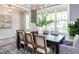 Elegant dining room with natural light, stylish chandelier, and seating for six at 6059 Scalybark Road, Durham, NC 27712