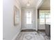 Welcoming foyer featuring hardwood floors and a modern chandelier at 6059 Scalybark Road, Durham, NC 27712