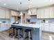 Modern kitchen with a central island, sleek countertops, stainless steel appliances and stylish pendant lighting at 6059 Scalybark Road, Durham, NC 27712