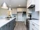 Modern kitchen featuring a central island, sleek countertops, and stainless steel appliances at 6059 Scalybark Road, Durham, NC 27712