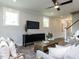 Cozy living room featuring a TV, stylish furniture, and plenty of natural light at 6059 Scalybark Road, Durham, NC 27712