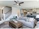 Inviting living room seamlessly connects to a modern kitchen and a staircase leading to the upper level at 6059 Scalybark Road, Durham, NC 27712