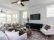 Comfortable living room featuring stylish decor and a large entertainment console at 6059 Scalybark Road, Durham, NC 27712
