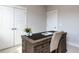 Dedicated office space featuring a wooden desk with storage, a comfortable chair and natural light at 6059 Scalybark Road, Durham, NC 27712
