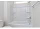 Clean white bathroom featuring a tub with showerhead and a white toilet at 6060 Scalybark Rd, Durham, NC 27712