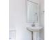 Bathroom with pedestal sink, mirror, and towel rack at 6060 Scalybark Rd, Durham, NC 27712