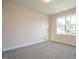 Bedroom featuring soft carpet, a window overlooking the neighborhood, and neutral wall color at 6060 Scalybark Rd, Durham, NC 27712