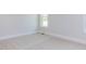 Bedroom with neutral carpet, window, and white walls at 6060 Scalybark Rd, Durham, NC 27712