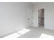 Bright bedroom featuring neutral carpet, fresh paint and ensuite closet at 6060 Scalybark Rd, Durham, NC 27712
