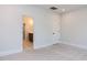 Bedroom with walk-in bathroom, neutral carpet, and white walls at 6060 Scalybark Rd, Durham, NC 27712