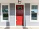 A close-up of a red front door with sidelights, showcasing modern design at 6060 Scalybark Rd, Durham, NC 27712