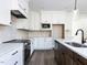 Modern kitchen features white cabinetry, stainless steel appliances, and granite countertops at 6060 Scalybark Rd, Durham, NC 27712