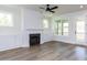 Bright living room with a fireplace, built-in cabinets, and access to outdoor space at 6060 Scalybark Rd, Durham, NC 27712