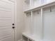 Mudroom with built-in cubbies, bench, and hooks at 6060 Scalybark Rd, Durham, NC 27712