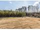 Large backyard with grassy area and tree line at 6063 Scalybark Road, Durham, NC 27712