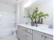 Bathroom with double vanity, large mirror and neutral tones at 6063 Scalybark Road, Durham, NC 27712