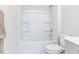 Clean bathroom with shower/tub combo and built in shelving at 6063 Scalybark Road, Durham, NC 27712