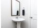 Simple bathroom with pedestal sink and mirror at 6063 Scalybark Road, Durham, NC 27712