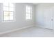 Simple bedroom with two windows and neutral color scheme at 6063 Scalybark Road, Durham, NC 27712