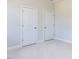 Spacious bedroom with neutral walls and two closets at 6063 Scalybark Road, Durham, NC 27712