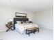 Main bedroom with king-size bed, neutral decor, and ample space at 6063 Scalybark Road, Durham, NC 27712