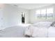 Spacious bedroom with ensuite bathroom access and large window at 6063 Scalybark Road, Durham, NC 27712