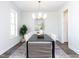 Bright dining room with a dark wood table and chandelier at 6063 Scalybark Road, Durham, NC 27712
