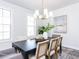 Bright dining room features a large table, chandelier, and natural light at 6063 Scalybark Road, Durham, NC 27712