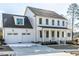 Two-story white house with gray roof, dormers, and two-car garage at 6063 Scalybark Road, Durham, NC 27712