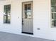 Gray front door with glass panels and black hardware at 6063 Scalybark Road, Durham, NC 27712