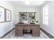 Home office with built-in shelving and a large desk at 6063 Scalybark Road, Durham, NC 27712