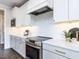 White kitchen with chevron backsplash and stainless steel appliances at 6063 Scalybark Road, Durham, NC 27712