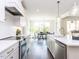 Modern kitchen with white cabinets, quartz counters, and stainless steel appliances at 6063 Scalybark Road, Durham, NC 27712