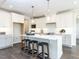 Modern kitchen with white cabinets and a large island at 6063 Scalybark Road, Durham, NC 27712