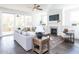 Living room with fireplace, hardwood floors, and access to a screened porch at 6063 Scalybark Road, Durham, NC 27712
