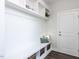 White mudroom with built-in bench and storage at 6063 Scalybark Road, Durham, NC 27712