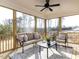 Relaxing screened porch with seating area and wooded views at 6063 Scalybark Road, Durham, NC 27712