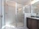 Large walk-in shower with glass enclosure and neutral tile at 6063 Scalybark Road, Durham, NC 27712