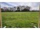 Expansive grassy backyard with a wood line provides ample outdoor space for recreation and enjoying nature at 234 Crystal Springs Way, Benson, NC 27504