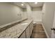 Updated bathroom boasts a granite-topped vanity and tile flooring, paired with a shower-tub combo at 234 Crystal Springs Way, Benson, NC 27504