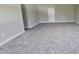 A bonus room has neutral carpet and walls, white baseboard trim, and a door to the far wall at 234 Crystal Springs Way, Benson, NC 27504