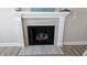 Close-up of the fireplace with a decorative mantle and gray tile surround at 234 Crystal Springs Way, Benson, NC 27504