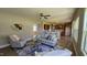 Open concept living room with a ceiling fan seamlessly connects to the kitchen at 234 Crystal Springs Way, Benson, NC 27504