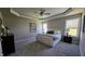 A spacious main bedroom is brightly lit with natural light from the double-hung windows and has soft gray carpet at 234 Crystal Springs Way, Benson, NC 27504